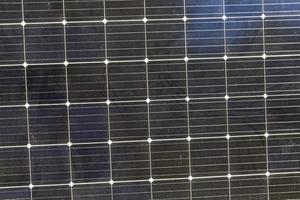 black solar panels illuminated by sunlight photo