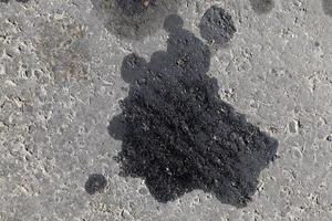 close up of car oil stains on the road photo