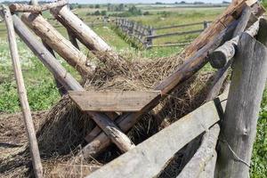 old fence and wooden feeders photo