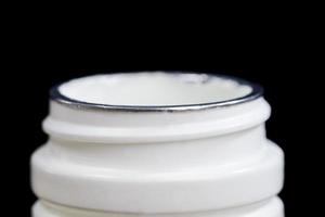 an open white plastic jar photo