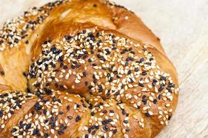 wheat bun sprinkled with sesame and flax photo