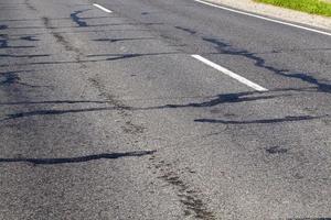 part of an asphalt road with damage photo