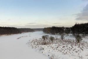 frozen water in the river during frosts photo