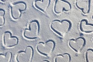 a heart symbol drawn on snow photo