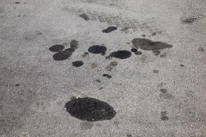 car oil stains on an asphalt road photo