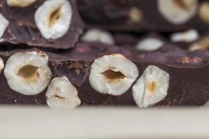 milk chocolate with whole and chunks of hazelnuts photo