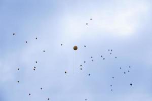 balloons with helium in sky photo