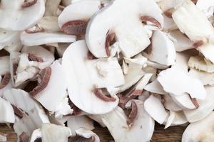 champignon mushrooms cut for heat treatment photo