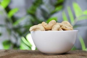 fresh raw cashew nuts on the kitchen table photo