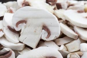 champignon mushrooms cut for heat treatment photo