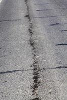 part of an asphalt road with damage photo