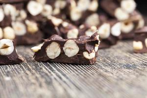 delicious milk homemade chocolate with lots of hazelnuts photo