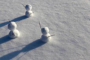 games in the snow with the creation of several snowman figures photo