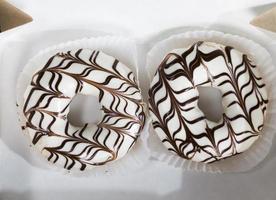 delicious doughnuts with chocolate covered filling, close up photo