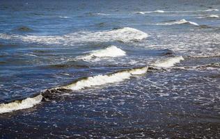 sea coast with lots of waves from windy weather photo