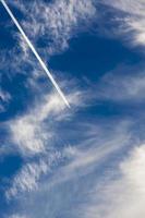 fast transport leaves behind a white contrail trail photo
