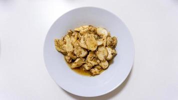 stir fried king oyster mushroom on white plate photo