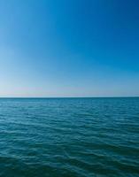 Vertical front view landscape Blue sea and sky blue background morning day look calm summer Nature tropical sea Beautiful  ocen water travel Bangsaen Beach East thailand Chonburi Exotic horizon. photo