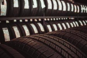 New tires on the shelves of tire service workshops. photo