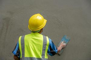 Plasterers are plastering walls in building construction with mortar and concrete. photo