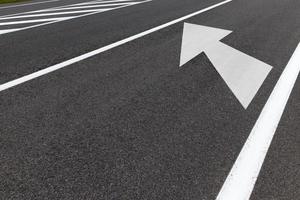 asphalted road with arrows photo