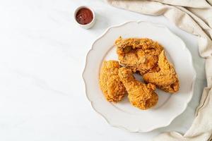 fried chicken with ketchup on plate photo