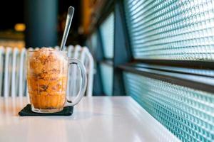 Thai tea ice scoop in glass photo