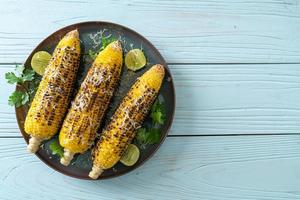 barbecue and grilled corn with cheese and lime photo