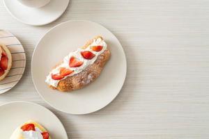 strawberry fresh cream croissant on plate photo