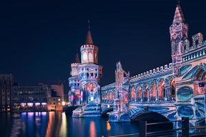 the Oberbaumbruecke in Berlin 2021 to the festival of lights. The bridge shines in full color splendor. an event of the extra class. photo