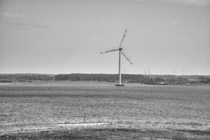 offshore wind turbine in black white. Green energy of the future. Renewable power supply photo