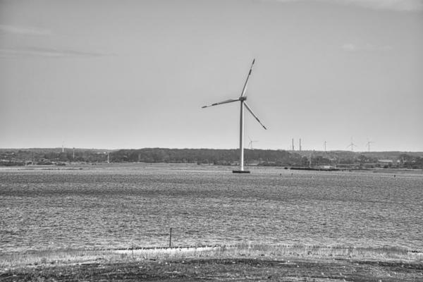 offshore wind turbine in black white. Green energy of the future. Renewable power supply