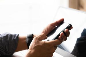 Man's hand using mobile phone with copy space white background photo