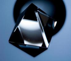 Abstract still life image with geometric objects. Glass pyramid in a low key. photo