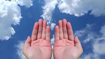 beautiful two hand open. sky and cloud background with copy space photo
