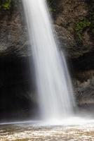 A natural waterfall in a big forest in the midst of beautiful nature. photo