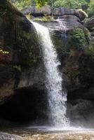 A natural waterfall in a big forest in the midst of beautiful nature. photo