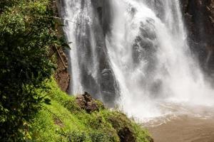 A natural waterfall in a big forest in the midst of beautiful nature. photo