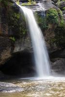 A natural waterfall in a big forest in the midst of beautiful nature. photo