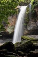 A natural waterfall in a big forest in the midst of beautiful nature. photo