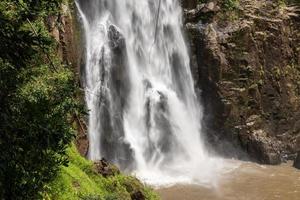 A natural waterfall in a big forest in the midst of beautiful nature. photo