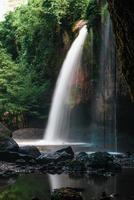 A natural waterfall in a big forest in the midst of beautiful nature. photo