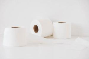 Rolls of white toilet paper on a white background photo