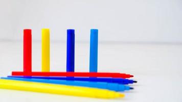 Multicolored felt-tip pens on a white background photo