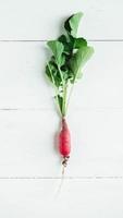 Fresh radishe on a white wooden background photo