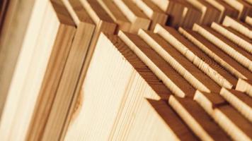 Stacked wooden carpentry boards from natural wood in a woodworking industry photo