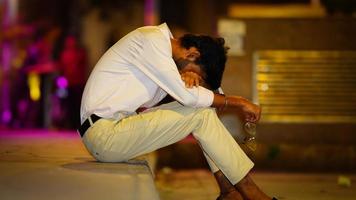 sad man sitting in road side photo