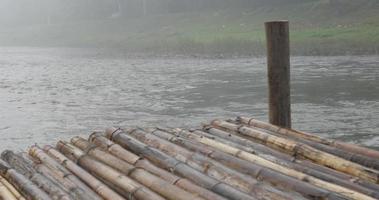 Bamboo pier with fog over the river . video