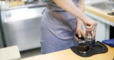 Tamping fresh coffee to make ground coffee video