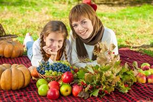 Happy mother with little daughter in autumn park photo